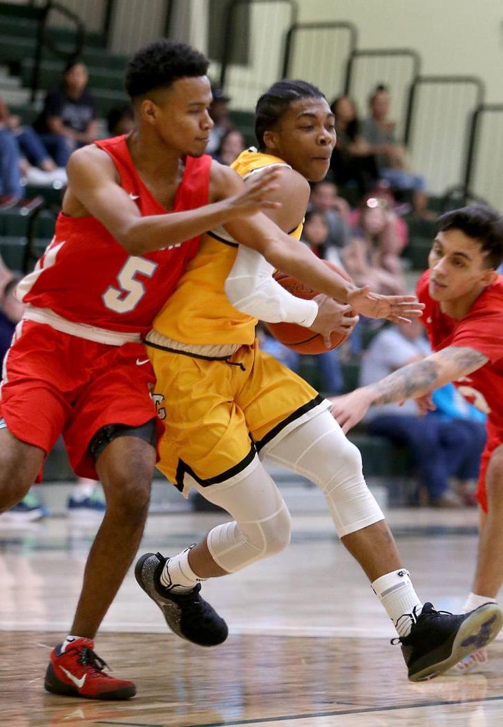 Central's Jalen Menzies drives between Mesa defenders in Saturday night win.-Oscar Perez Pinal Central